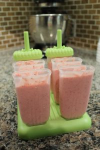 Strawberry Popsicles in popsicle molds before freezing