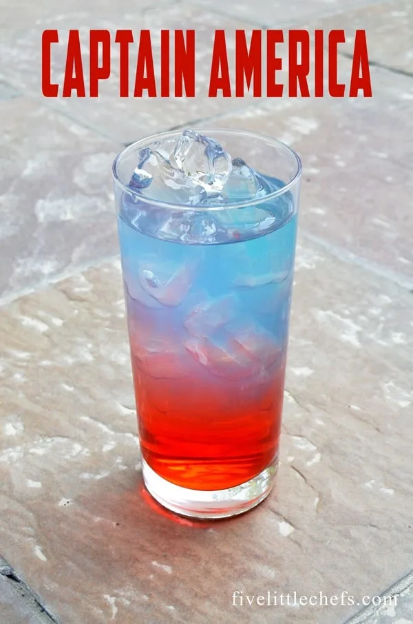 Colorful non-alcoholic drink, red and blue, in tall glass filled with ice