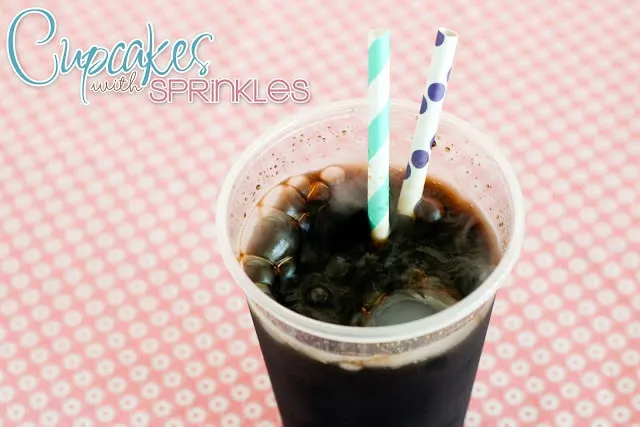 Glass of homemade rootbeer with colorful straw