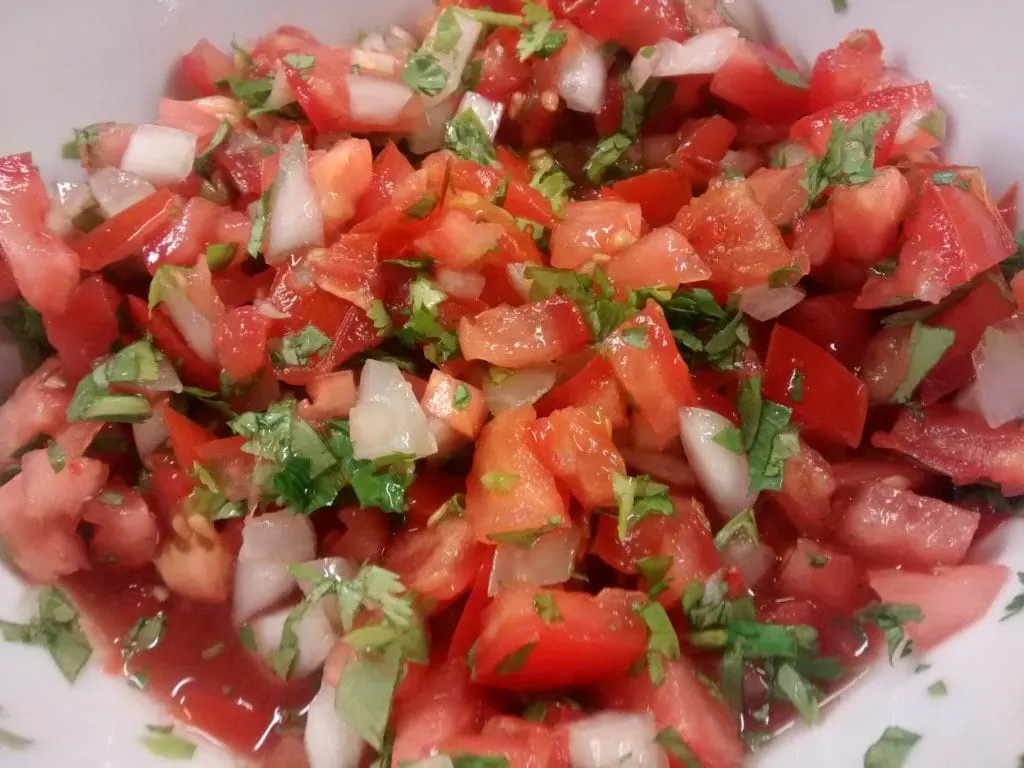 Fresh salsa with tomatoes, onion and cilantro in a bowl