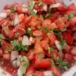 Fresh salsa with tomatoes, onion and cilantro in a bowl