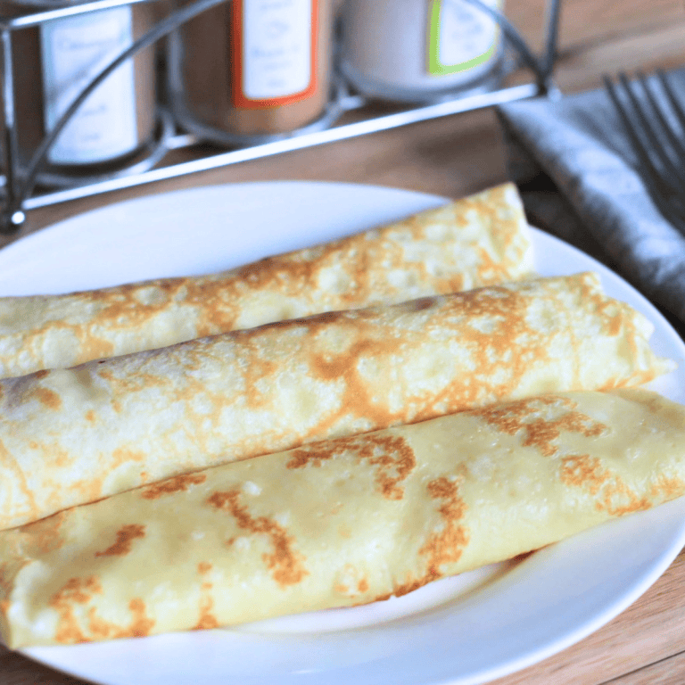White round plate with 3 rolled crepes.