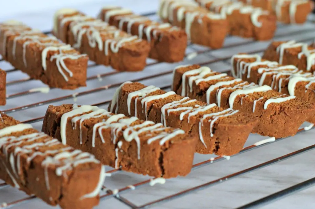 Rows of freshly baked Gingerbread Biscotti Cookies cooling on a rack