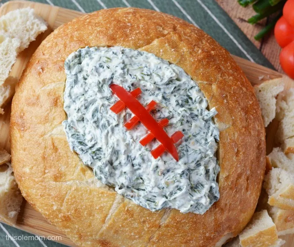 Spinach Dip in bread bowl with football cut out