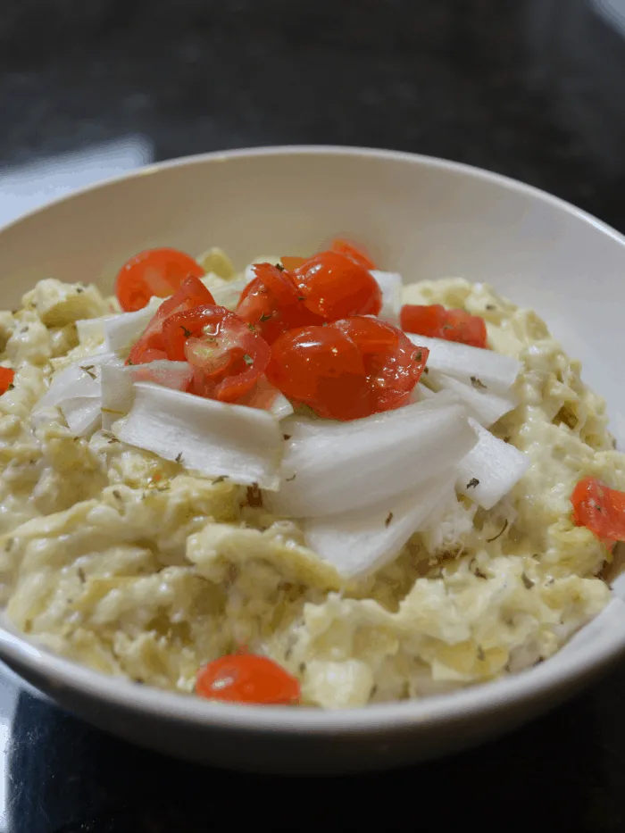 Hot Artichoke Dip in white bowl