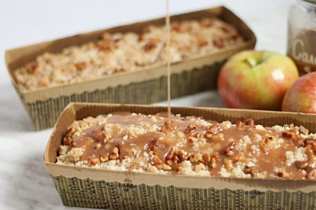 Caramel Apple Coffee Cake with Caramel Drizzle in small paper loaf pans with apples in background