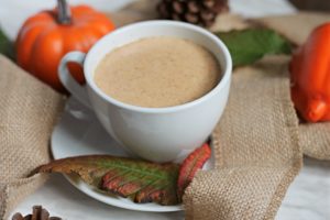 White tea cup with Pumpkin Hot Chocolate on burlap