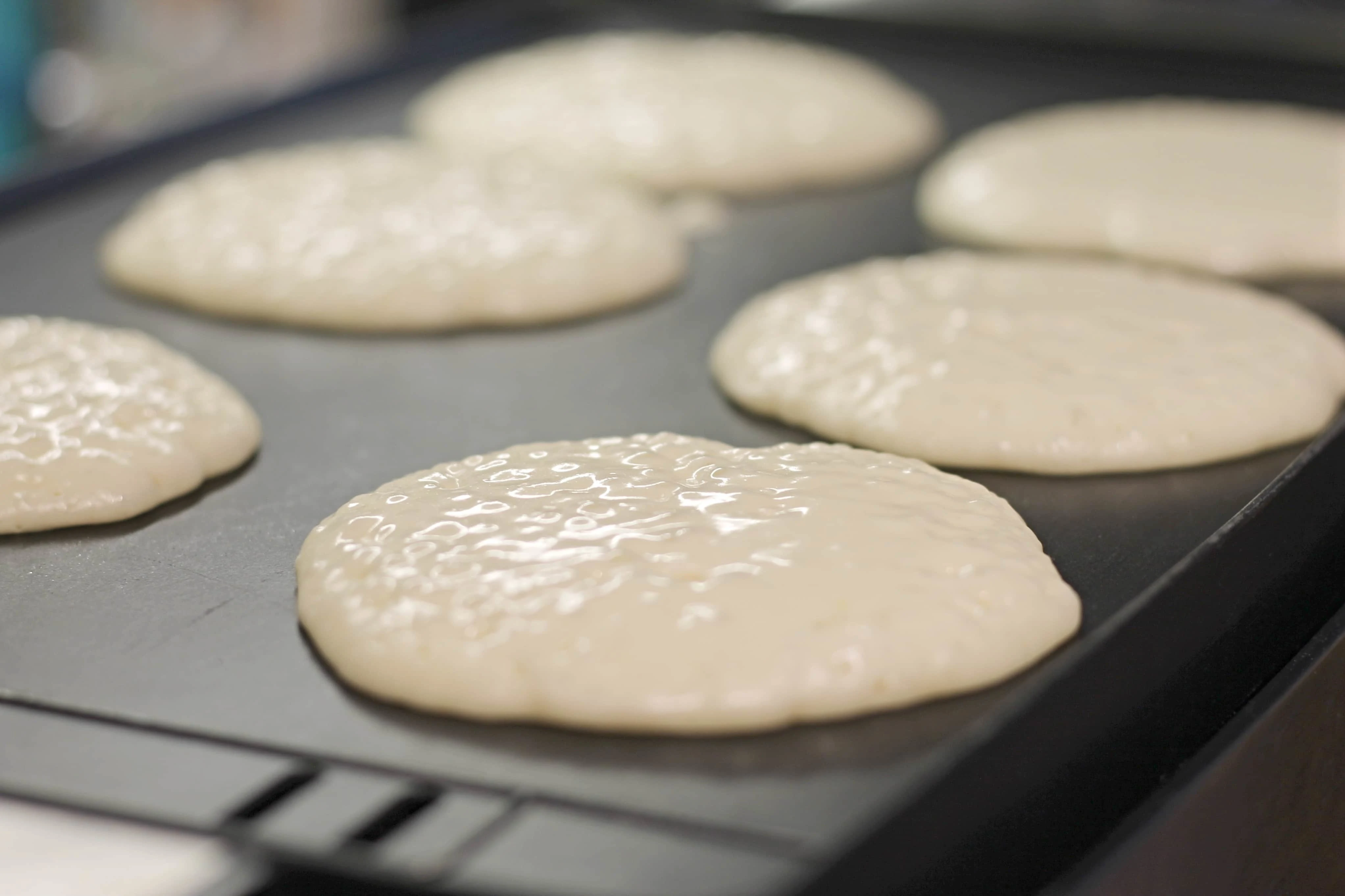 6 Fluffy Pancakes cooking on Griddle