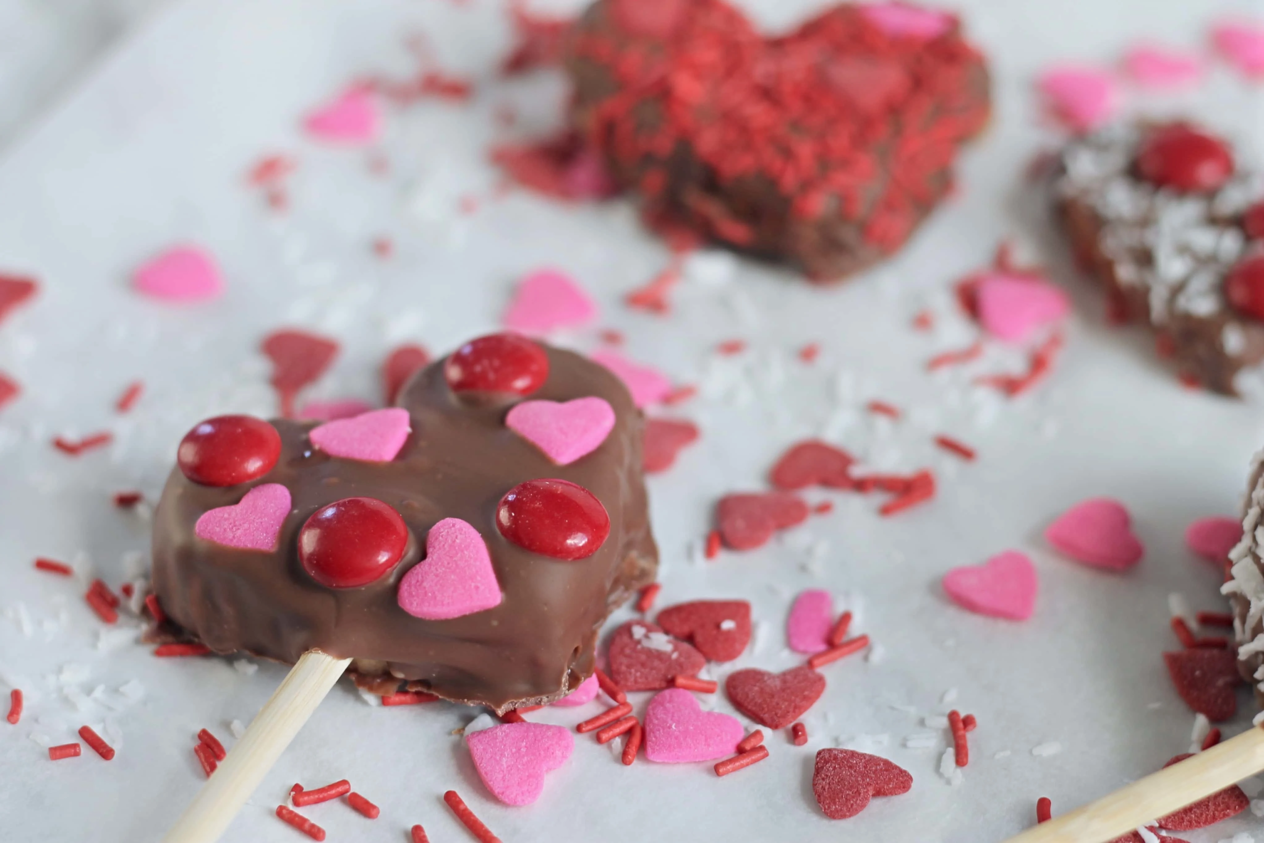 Chocolate Dipped Apple Hearts with heart sprinkles and candy coated chocolate