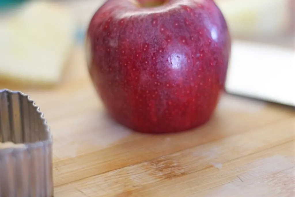 Apple on cutting board with bottom cut flat.