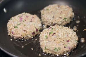 tuna cakes cooking in frying pan 