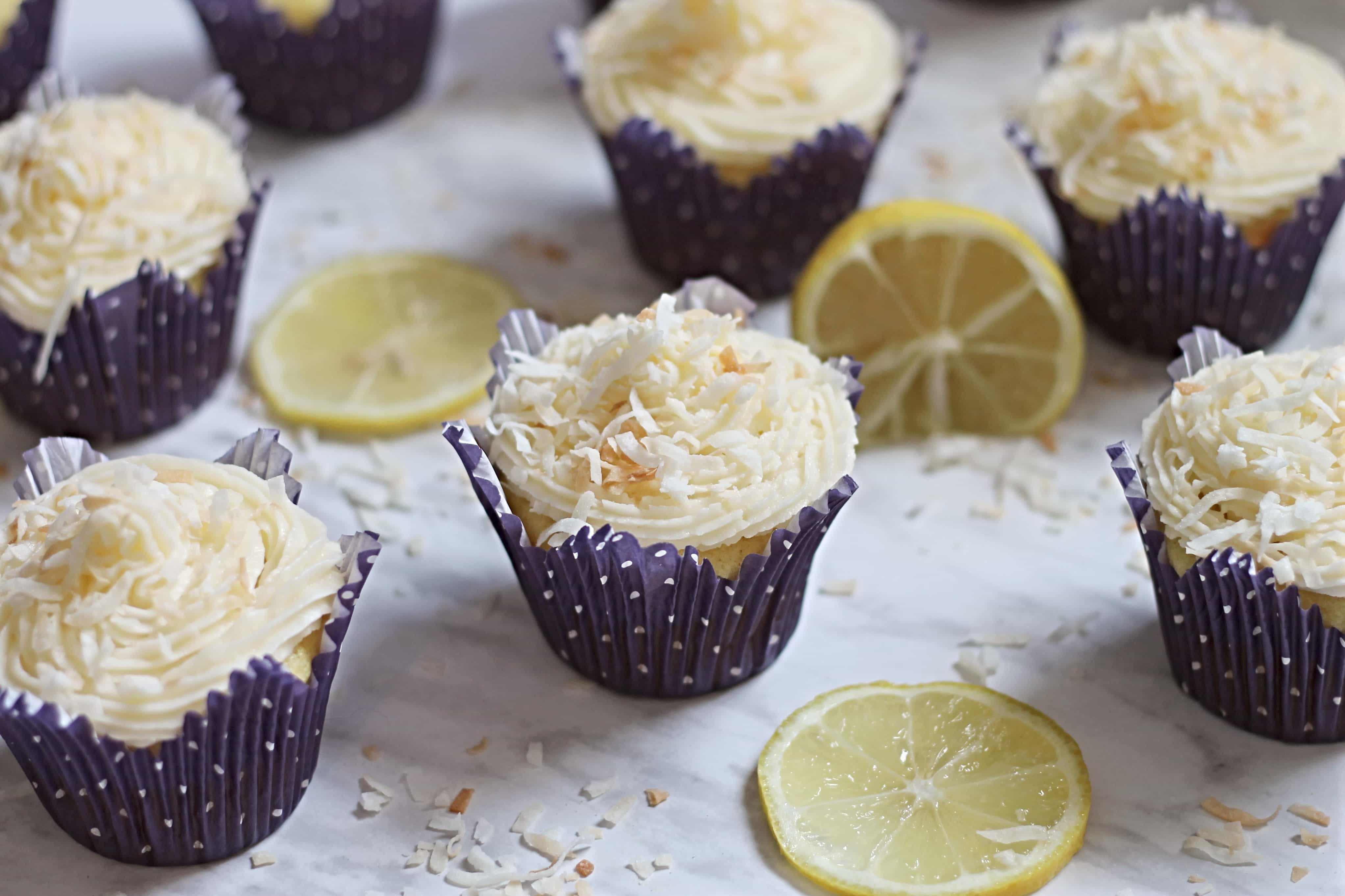 Lemon Cupcakes in purple cupcake liners on marble counter