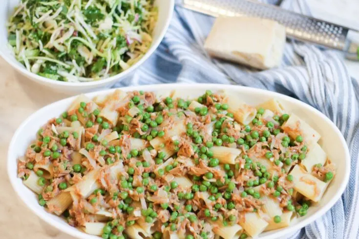 Tuna Pasta in white casserole dish with Parmesan Cheese and Salad