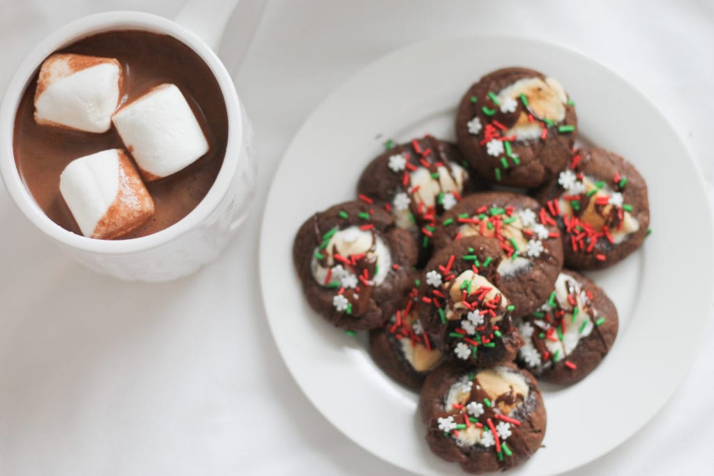 Finished hot chocolate cookies on white plate with full cup of hot cocoa 