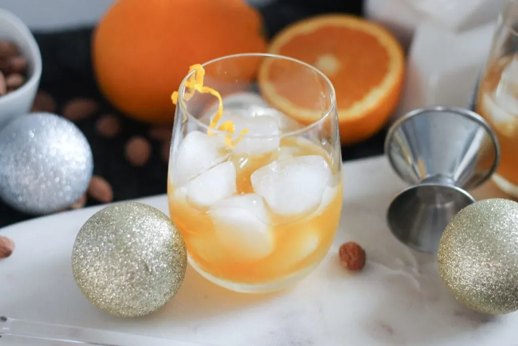 Easy Bourbon Cocktail in glass on marble cutting board