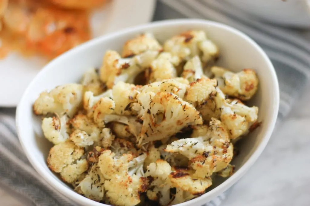 cooked cauliflower in white serving bowl