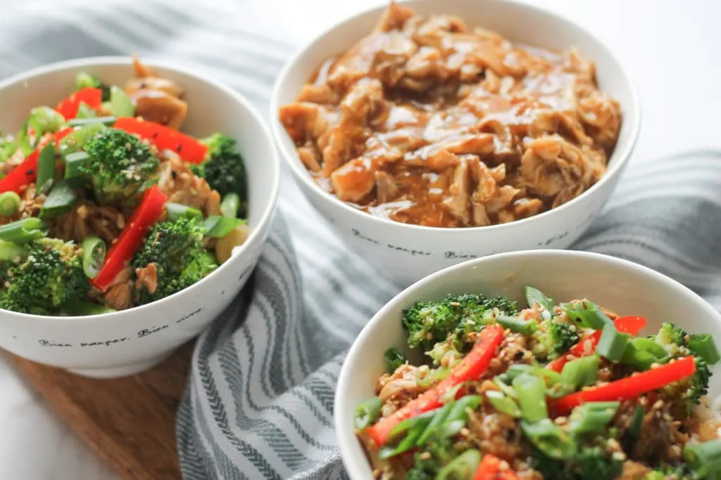 Sesame Chicken Stir-fry in two white bowls with vegetables