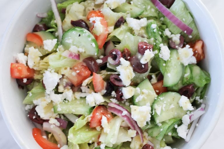 White bowl filled with Greek Salad.