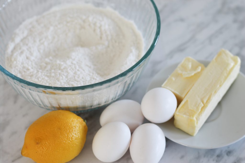 Ingredients for Lemon Cake on marble countertop.