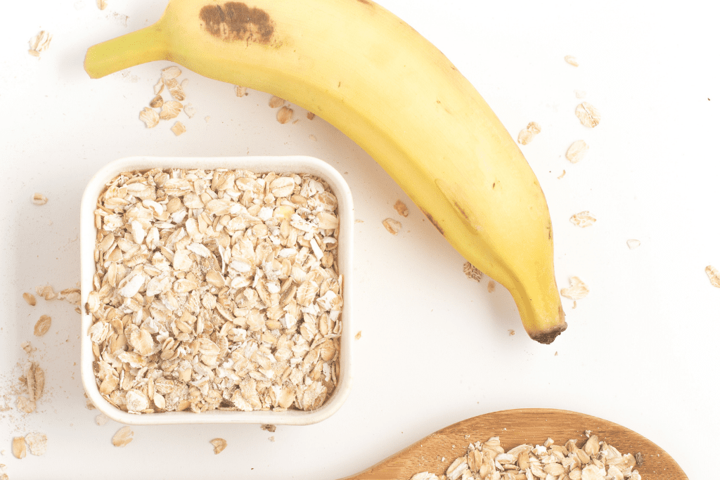 Banana on counter with bowl of oats.