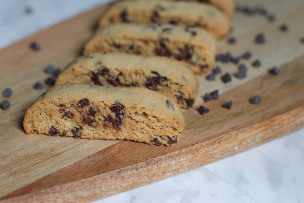 4 Chocolate Chip Biscotti cookies on wooden cutting board.