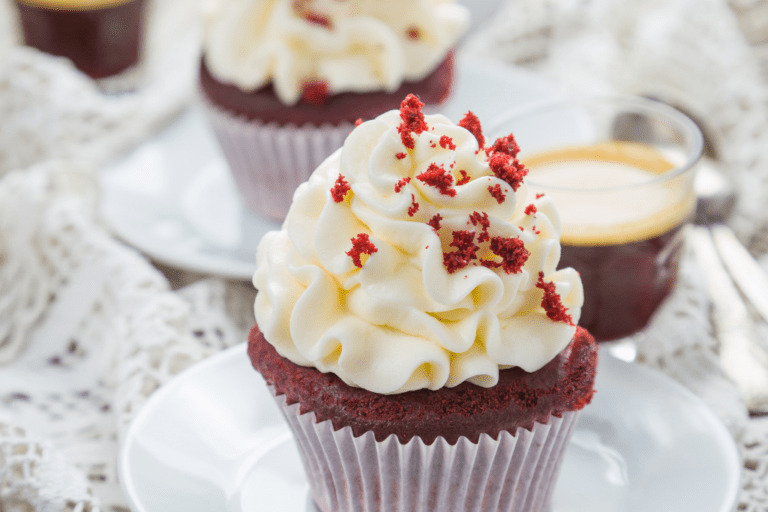 red velvet cupcakes on white plates.