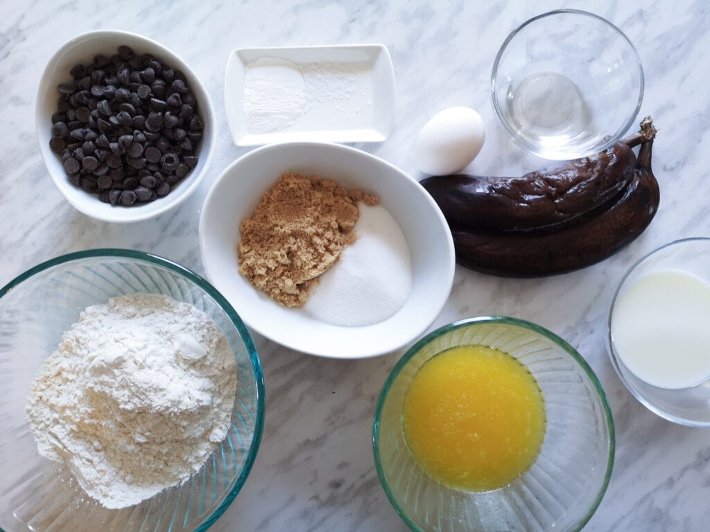 Ingredients for the banana bread on marble counter.