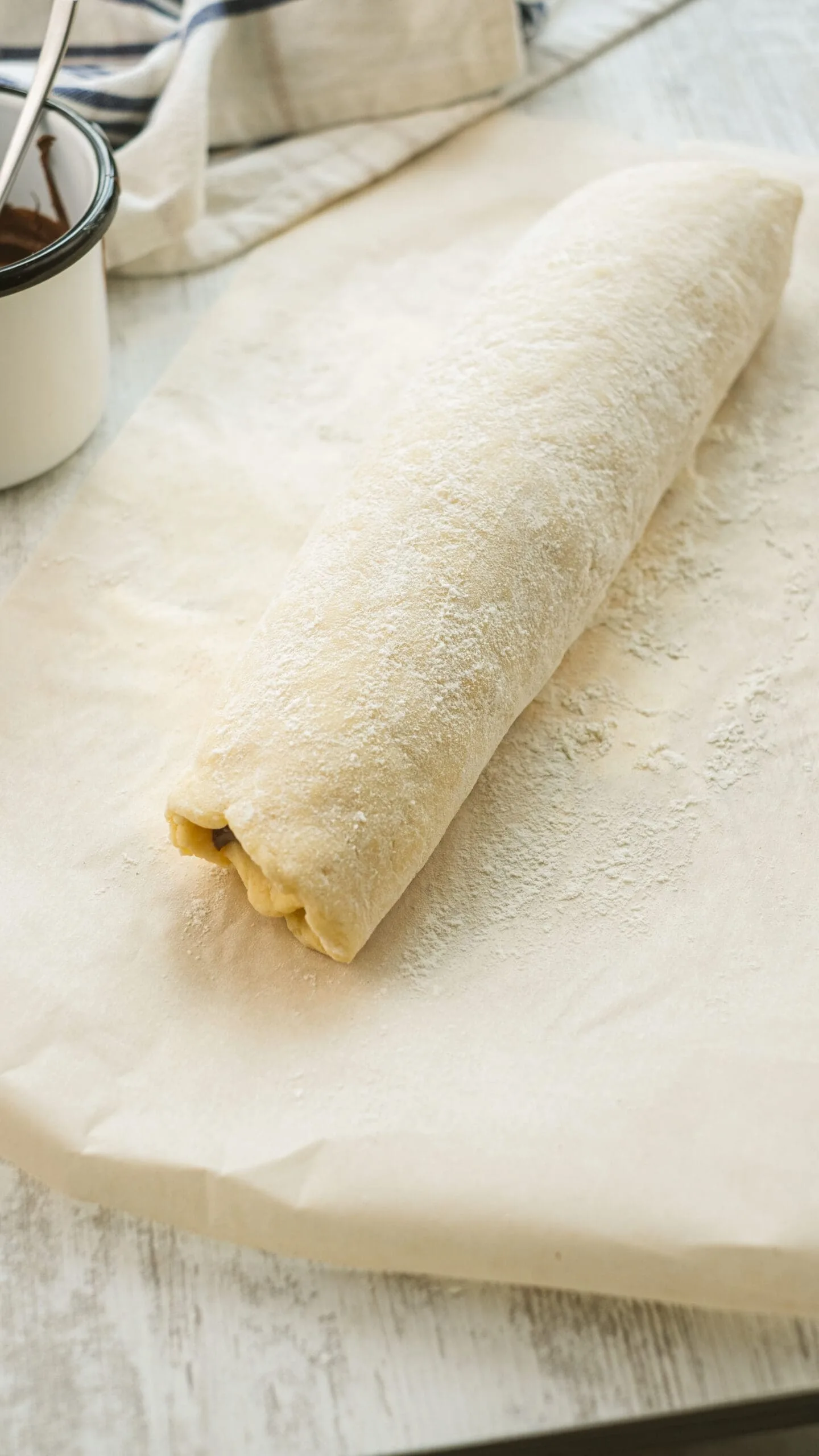Rolled bread dough on parchment paper.