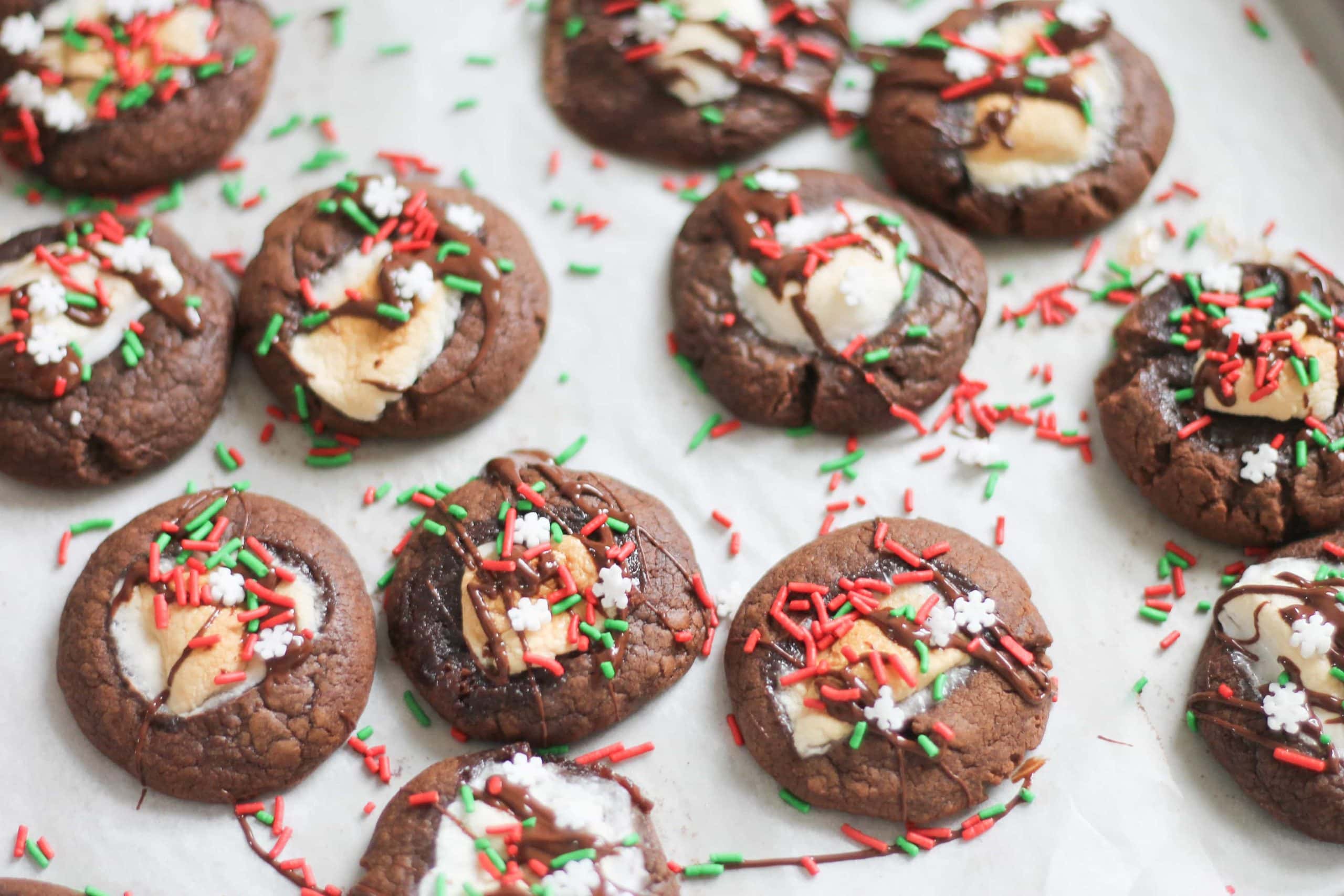 Cookie tray with hot chocolate cookies and Christmas Sprinkles scattered around.