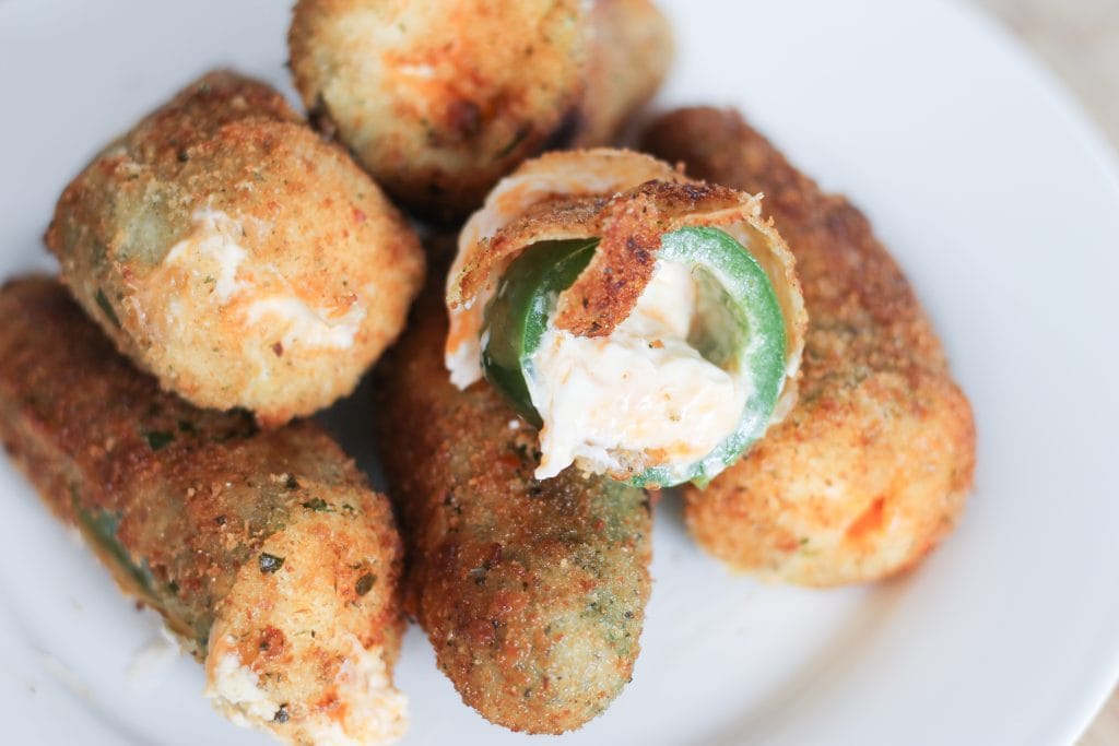 Cooked jalapeno popper with cheese oozing.