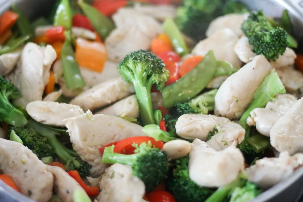 Close up of chicken and vegetable in pan for stir-fry