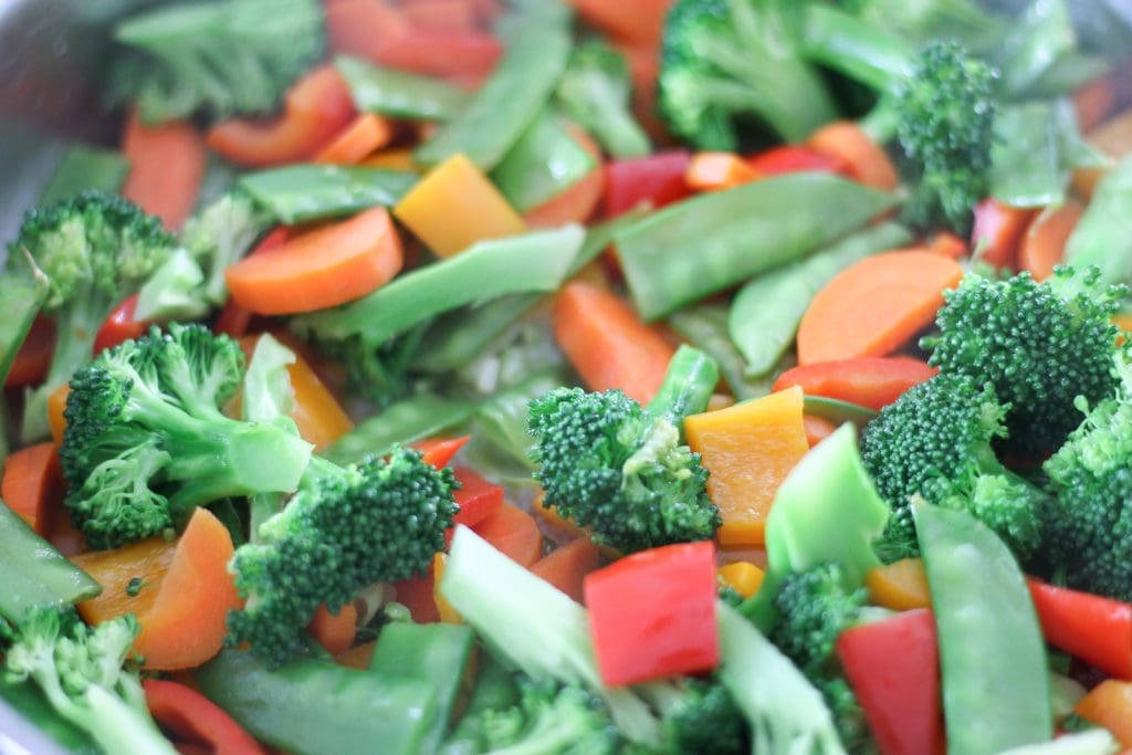 Vegetables in pan cooking for stir-fry.