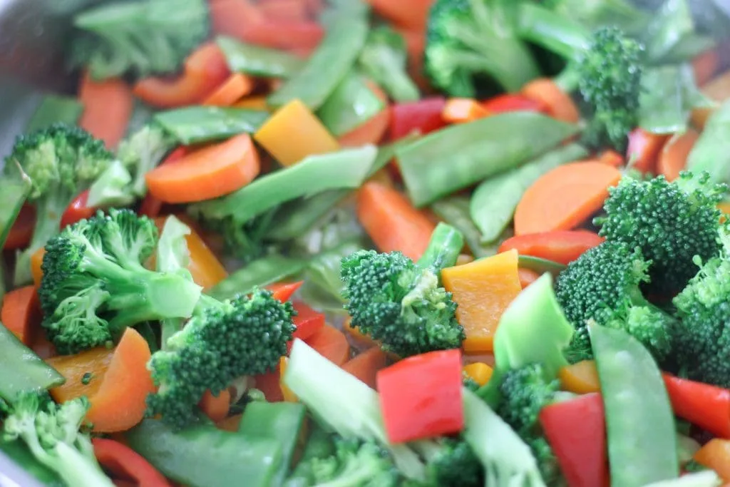 Vegetables in pan cooking for stir-fry.